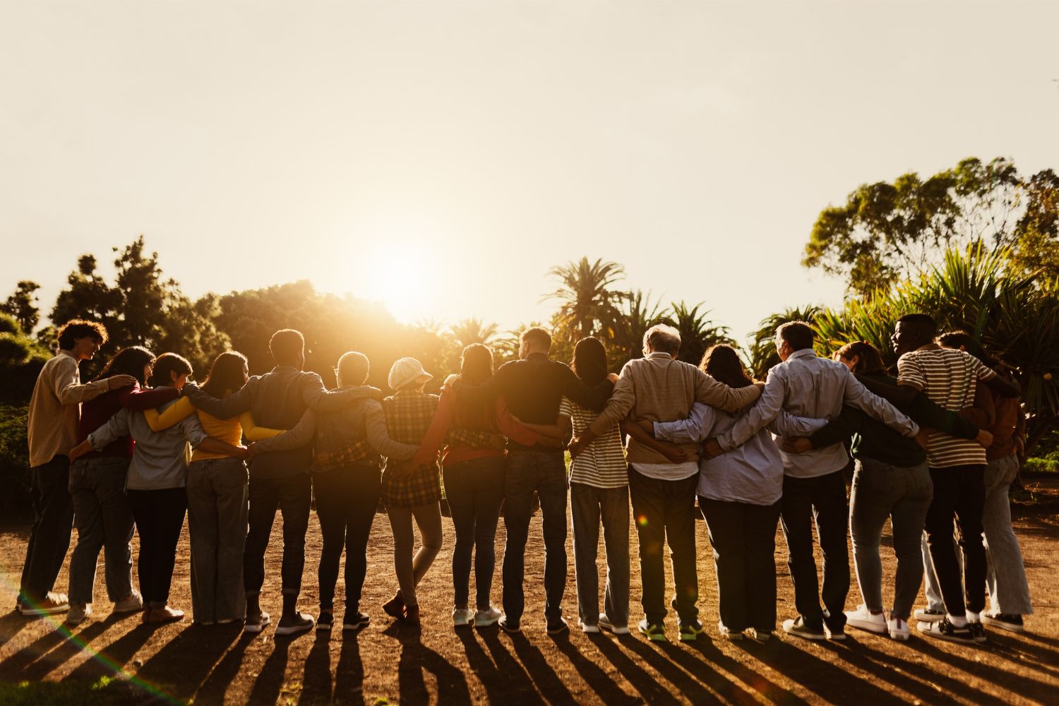 People holding each other during sunset