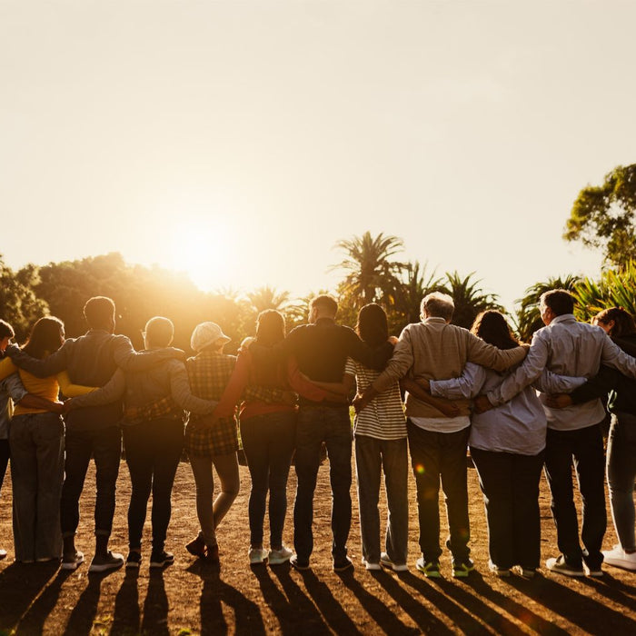 People holding each other during sunset